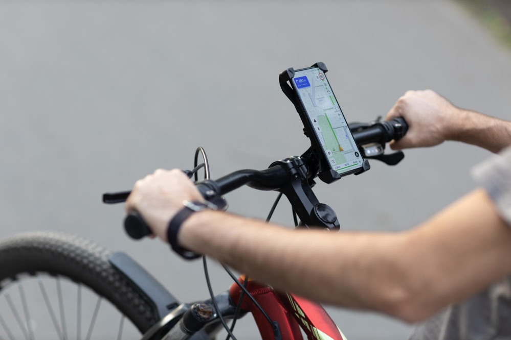 man-planning-route-using-gps-navigation-application-mobile-phone-his-bicycle-bike.jpg